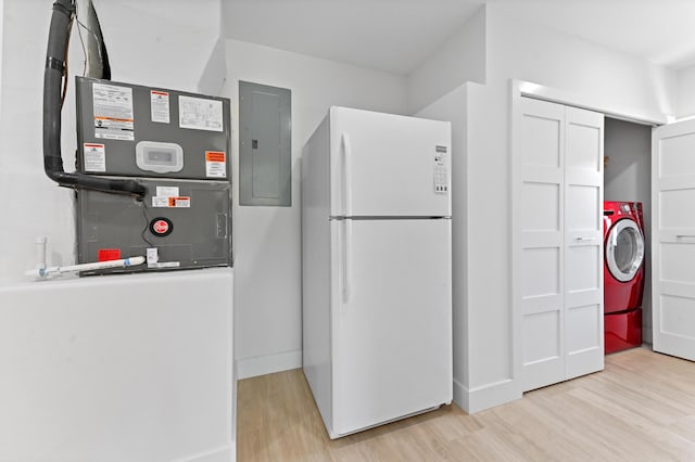 kitchen with electric panel, washer / clothes dryer, white fridge, and light wood-type flooring