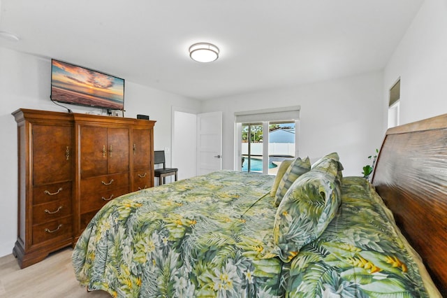 bedroom featuring access to outside and light hardwood / wood-style flooring