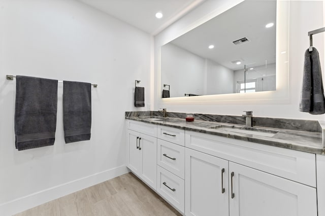 bathroom with hardwood / wood-style floors and vanity