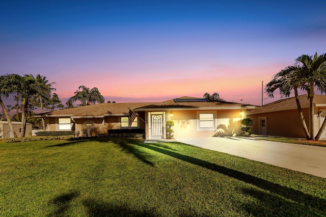 ranch-style home with a yard