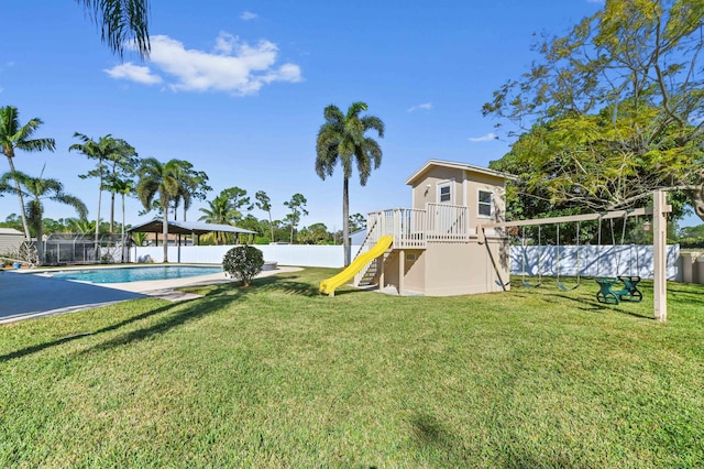 view of play area featuring a fenced in pool and a lawn