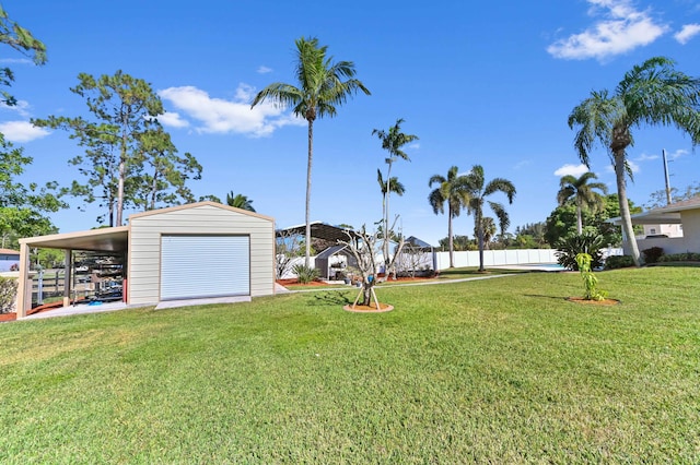 view of yard featuring a carport and an outdoor structure