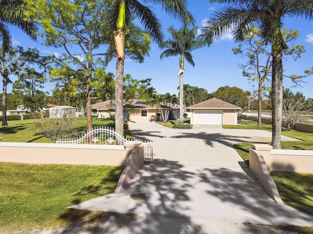 view of front of house with a garage and a front yard