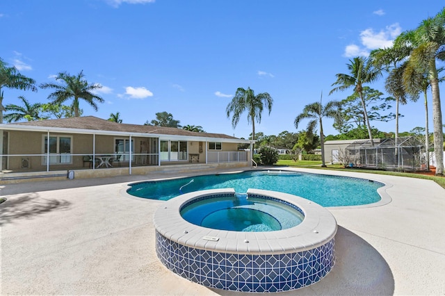 view of pool featuring a sunroom, a patio area, and an in ground hot tub