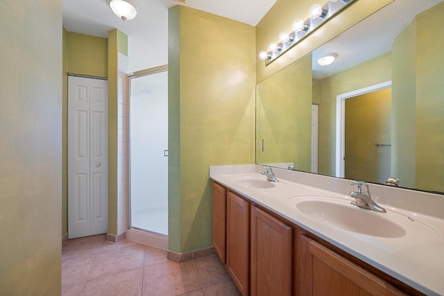 bathroom with tile patterned flooring, vanity, and a shower with shower door