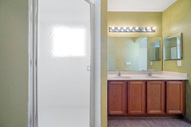 bathroom with tile patterned flooring, vanity, and a shower with door