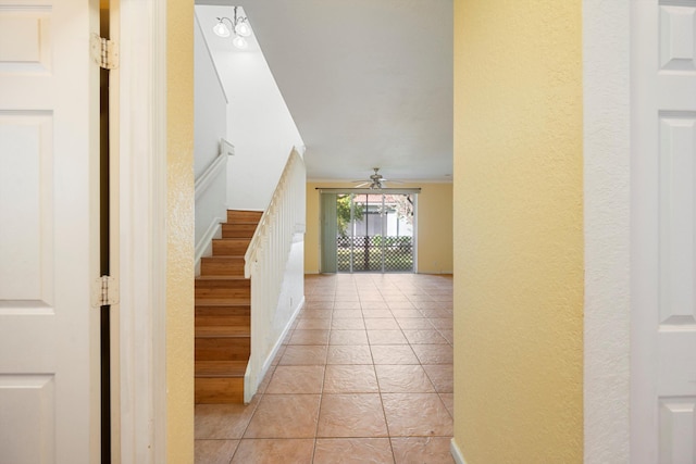 interior space with tile patterned flooring and ceiling fan