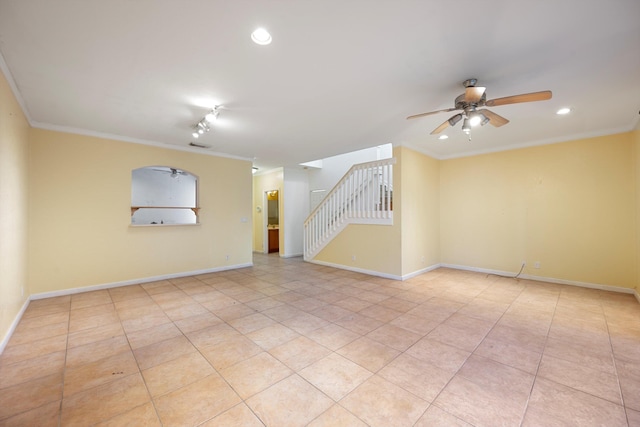 tiled empty room featuring ceiling fan and ornamental molding