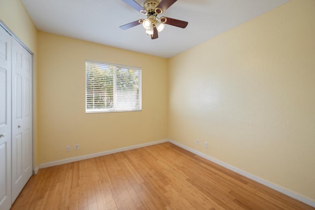 unfurnished bedroom featuring ceiling fan, light wood-type flooring, and a closet