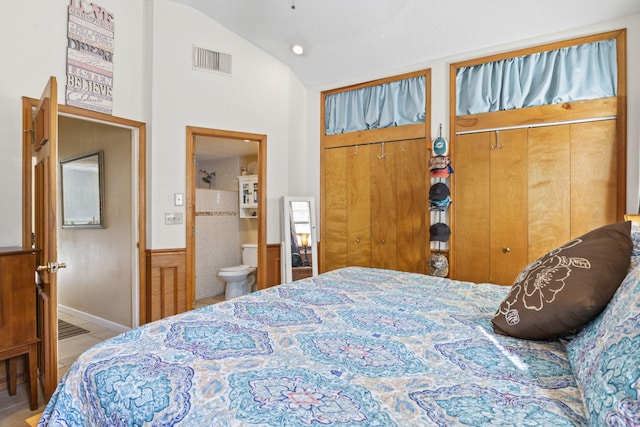 tiled bedroom with ensuite bathroom, a closet, and lofted ceiling