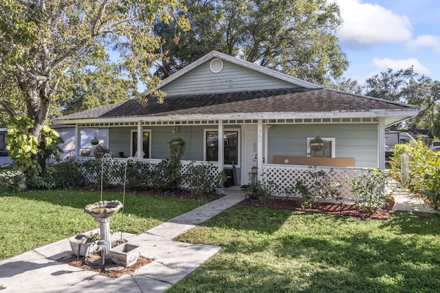 view of front facade featuring a front lawn and covered porch