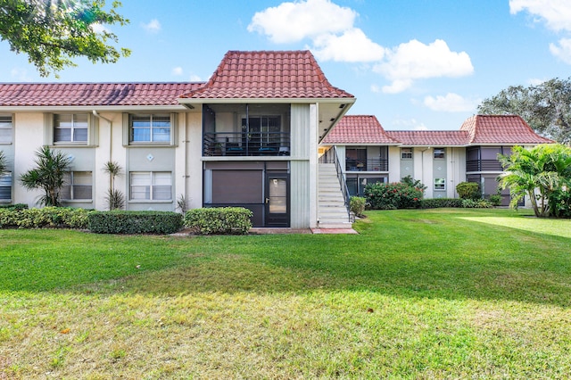 1124 NW 13th St Unit 218A, Boca Raton, FL 33486 - view of front of property with a tile roof, stairs, a front yard, and stucco siding
