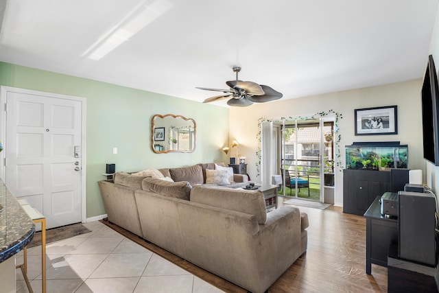 living room with ceiling fan and light hardwood / wood-style flooring