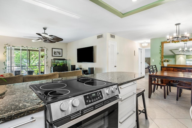 kitchen with decorative light fixtures, black electric range oven, white cabinetry, and ceiling fan with notable chandelier