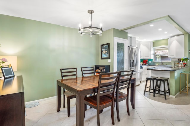 tiled dining space featuring an inviting chandelier