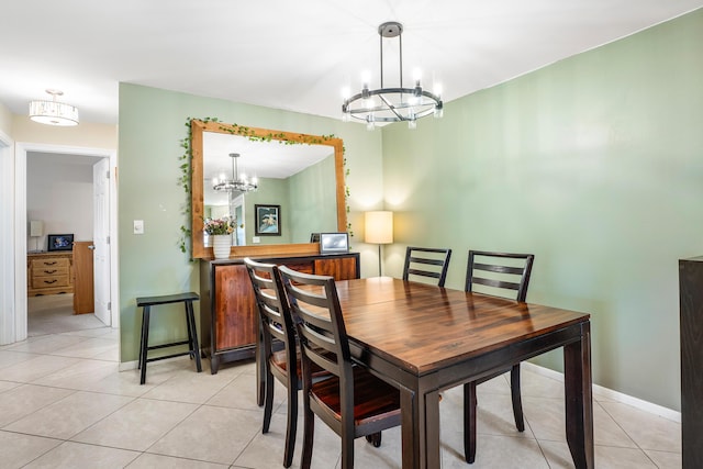 1124 NW 13th St Unit 218A, Boca Raton, FL 33486 - dining area featuring a chandelier, light tile patterned floors, and baseboards