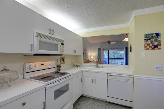 kitchen featuring a textured ceiling, white appliances, ceiling fan, sink, and white cabinets