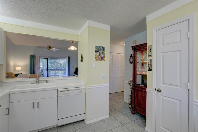 kitchen with ceiling fan, dishwasher, sink, a textured ceiling, and white cabinets