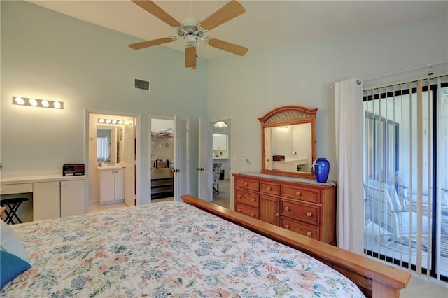 bedroom with ceiling fan, ensuite bathroom, a high ceiling, and a closet