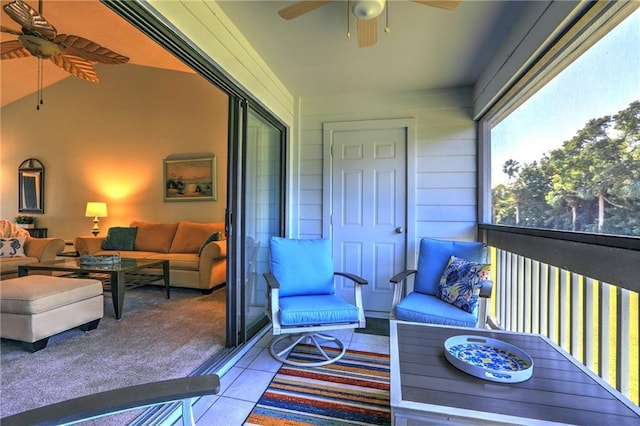 sunroom with ceiling fan and lofted ceiling