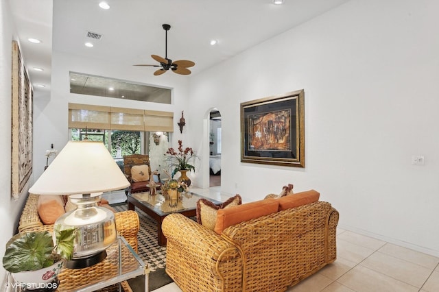 tiled living room with ceiling fan