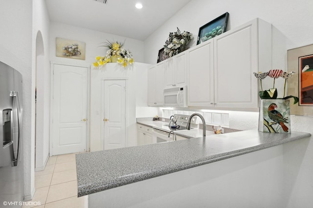 kitchen featuring kitchen peninsula, white cabinetry, light tile patterned floors, and appliances with stainless steel finishes