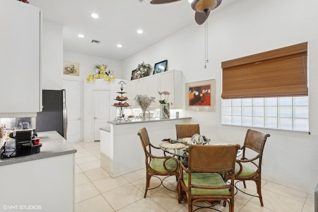 dining space with ceiling fan and light tile patterned floors