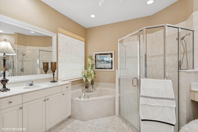 bathroom featuring shower with separate bathtub and vanity