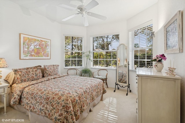 bedroom with ceiling fan and light colored carpet