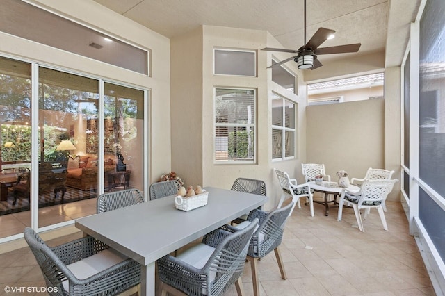 sunroom / solarium featuring ceiling fan and a healthy amount of sunlight