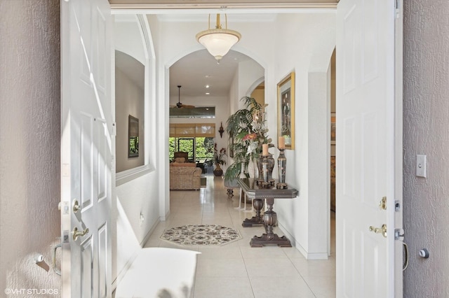 entryway featuring ceiling fan and light tile patterned floors