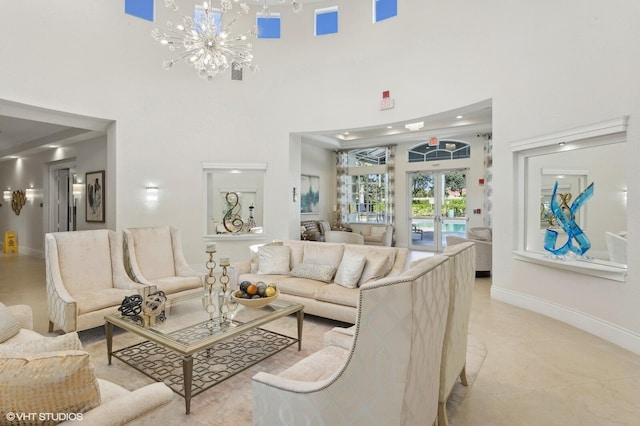 living room featuring french doors, a notable chandelier, and a high ceiling