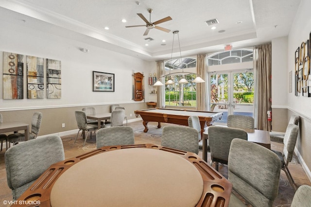 interior space featuring a raised ceiling, crown molding, french doors, and ceiling fan