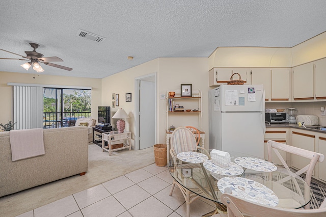 interior space with a textured ceiling and ceiling fan