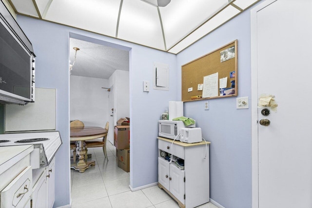 bathroom featuring tile patterned floors and a textured ceiling