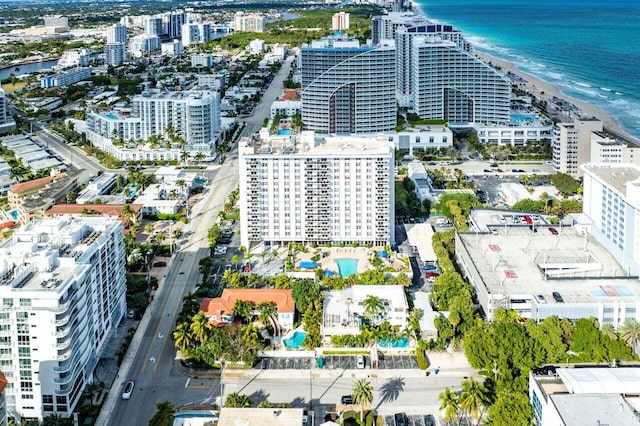 drone / aerial view featuring a water view and a view of the beach