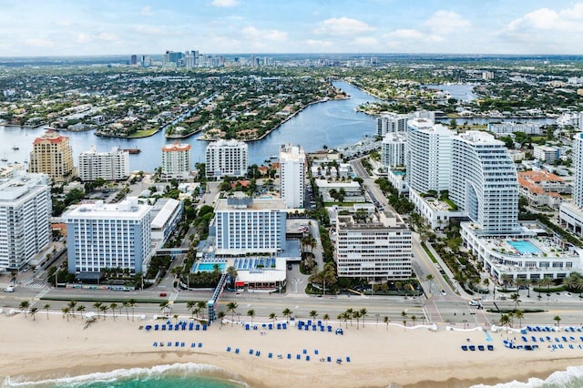 drone / aerial view featuring a water view and a beach view