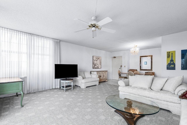 living room with light carpet, a textured ceiling, and ceiling fan with notable chandelier