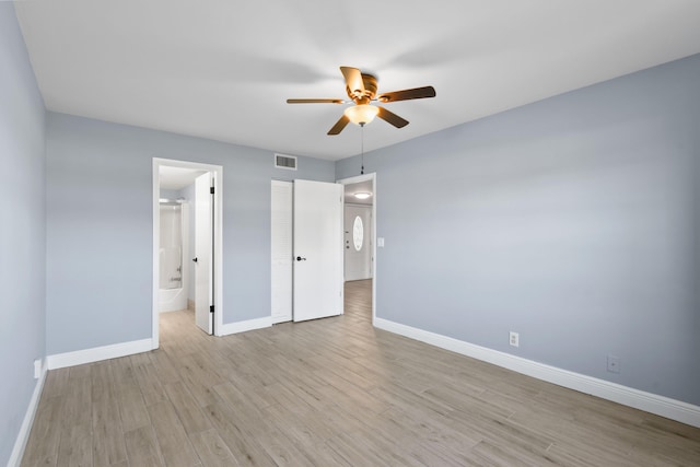 unfurnished bedroom featuring connected bathroom, ceiling fan, a closet, and light hardwood / wood-style floors