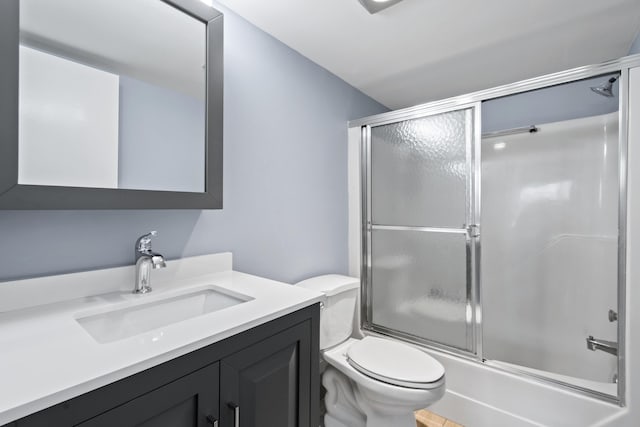 full bathroom featuring vanity, toilet, and enclosed tub / shower combo