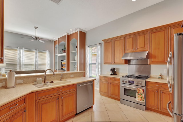 kitchen with ceiling fan, sink, light tile patterned floors, and stainless steel appliances