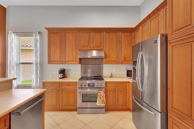 kitchen featuring stainless steel appliances and light tile patterned flooring