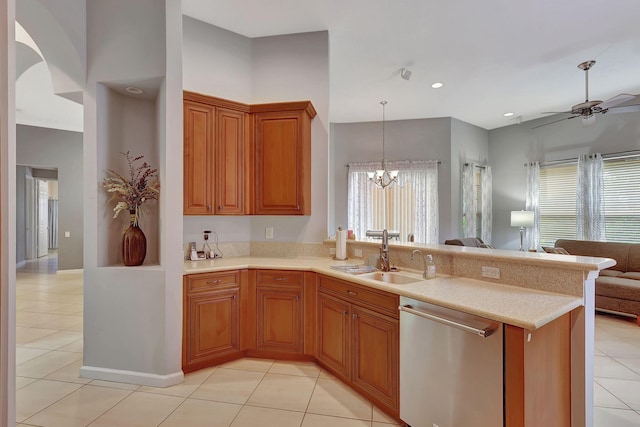 kitchen with kitchen peninsula, ceiling fan with notable chandelier, sink, dishwasher, and light tile patterned flooring