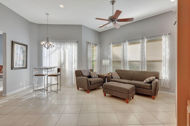 tiled living room featuring ceiling fan with notable chandelier