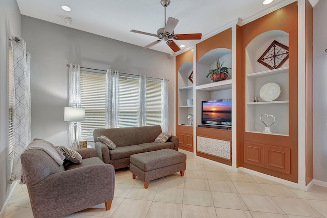 tiled living room featuring built in shelves, ceiling fan, and ornamental molding