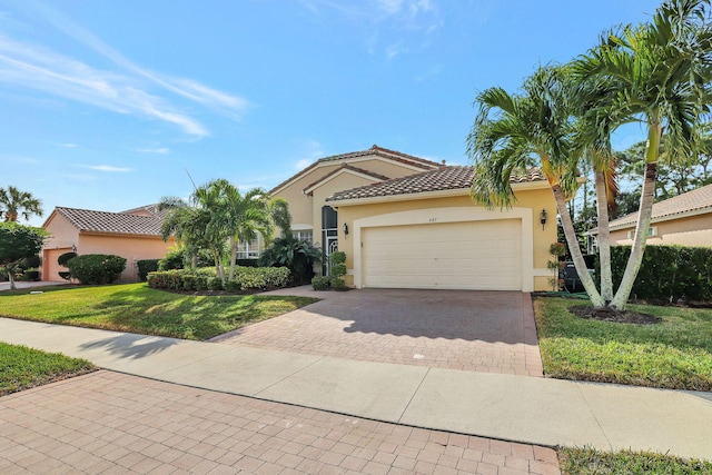 mediterranean / spanish home with a front yard and a garage