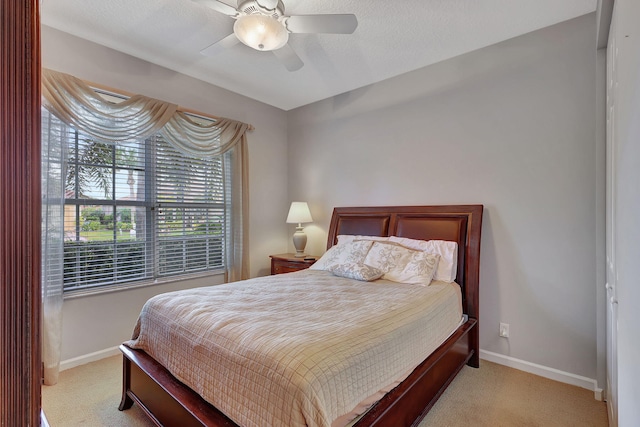 bedroom with ceiling fan, a closet, and light colored carpet