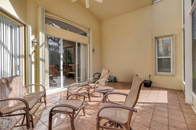 sunroom / solarium featuring ceiling fan and lofted ceiling