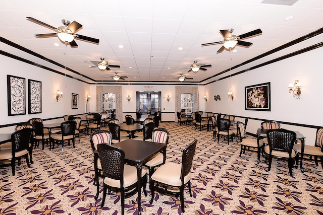 carpeted dining area featuring ceiling fan, crown molding, and french doors