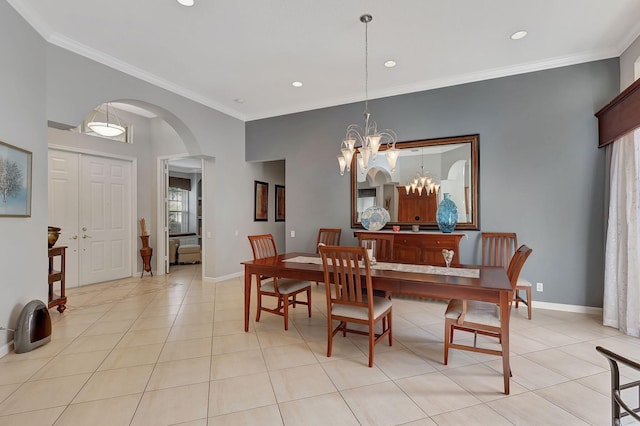 tiled dining area with a chandelier and ornamental molding